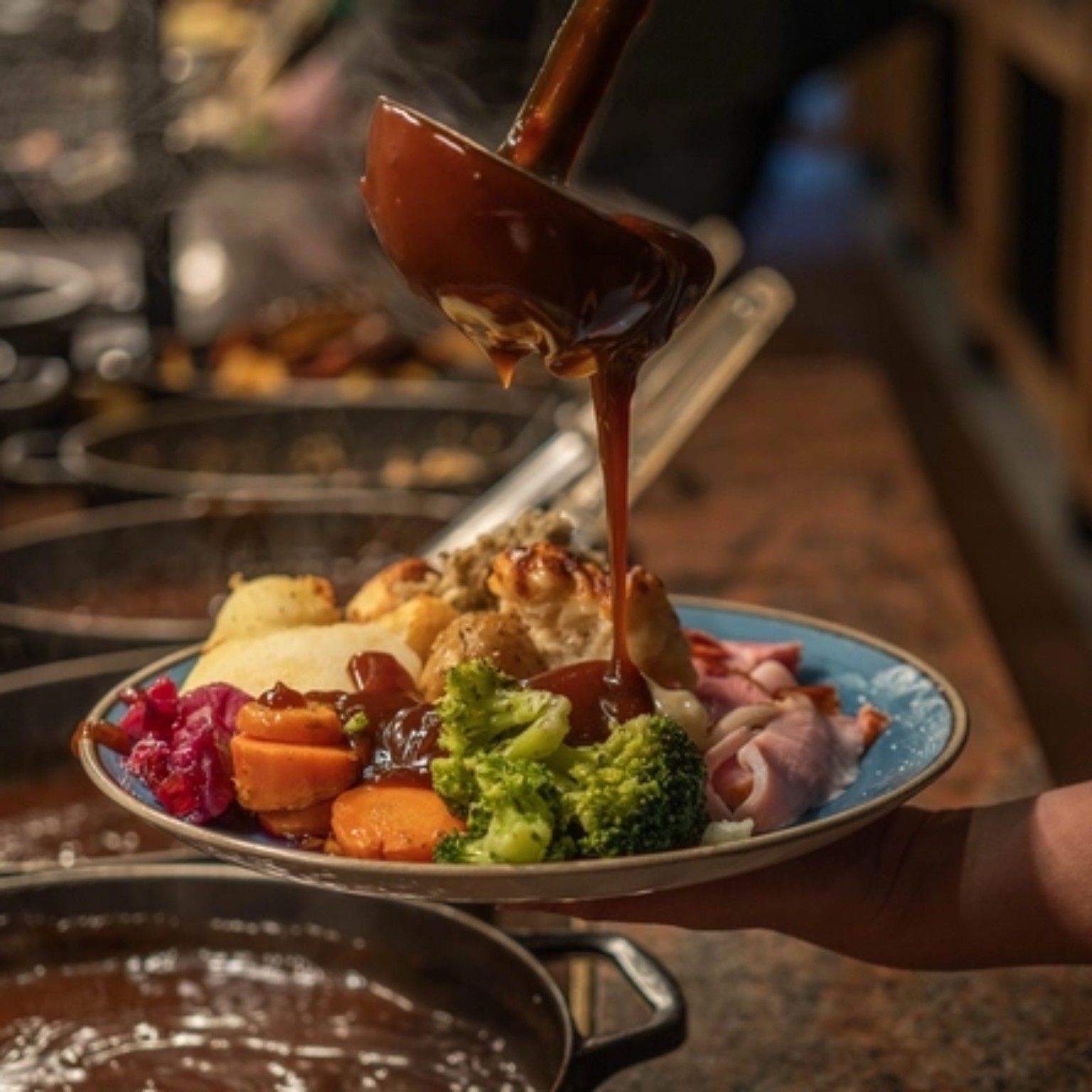Rich gravy poured over a traditional roast dinner